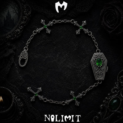 Green sterling silver coffin cross bracelet on a black gothic background