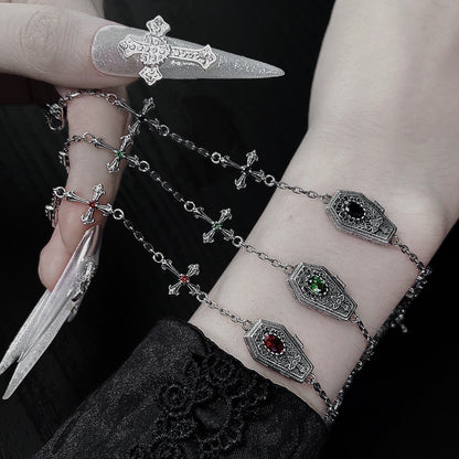 Red, green, and black sterling silver gothic coffin cross bracelets worn on the wrist